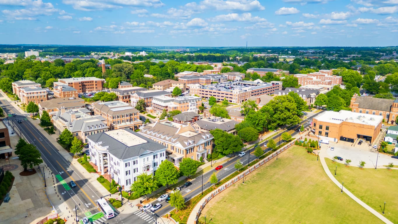 Aerial view of downtown Tuscaloosa, Alabama, with brick buildings and tree-lined streets